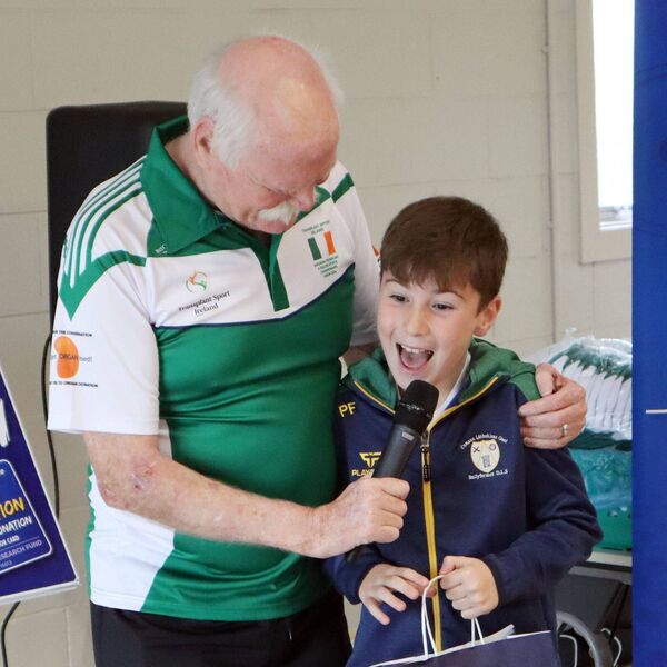 9-year-old Parker Flynn receiving a special presentation from team manager Harry Ward, for donating his communion money to register as an official supporter of the team