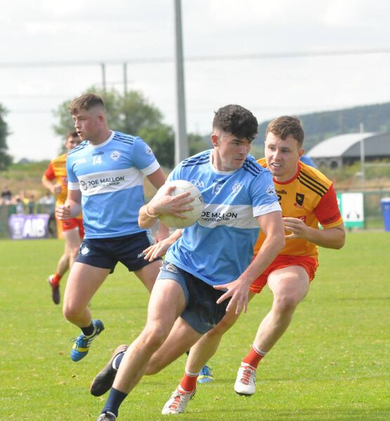 Joey Cunningham (Allenwood) gets past St Laurences defender Michael O'Sullivan 