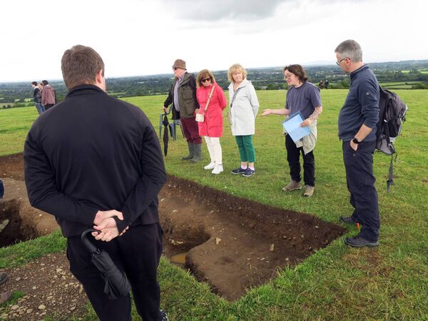 A student explains a detail of the excavation