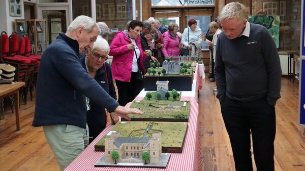 Visitors examining Michael O'Connell's local heritage models in Kilcullen