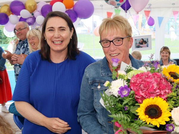 Iseult O'Donoghue presents a bouquet to Christine Nugent for her 25 years association with the Playgroup.