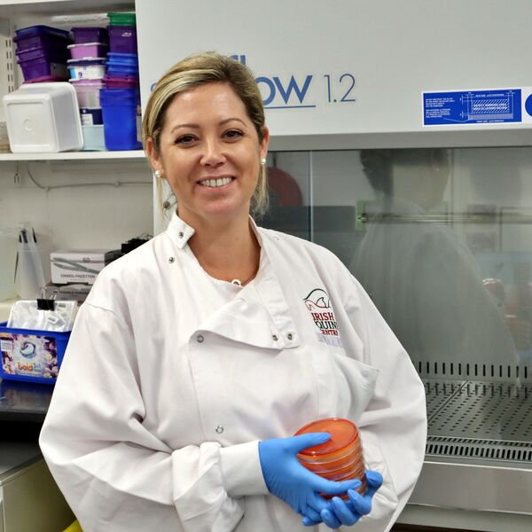 Kerrie Kavanagh, Senior Microbiologist at Pet Vet Lab, with a stack of samples