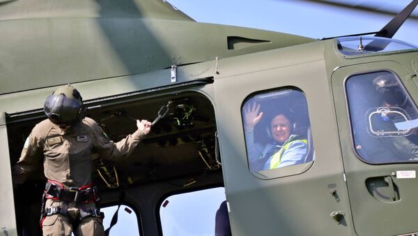CPC Kilcullen TY Coordinator Glenda Groome waves from the helicopter as it comes to land