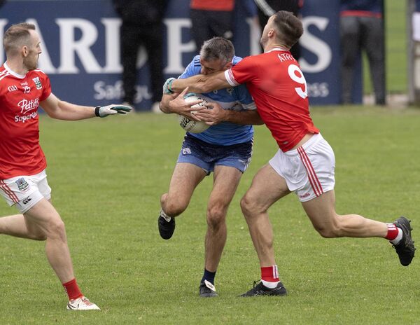 Johnny Doyle is tackled by Athy's Paschal Connell Photo: Sean Brilly