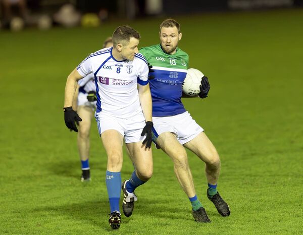 Johnstownbridge's Kelvin McNally and Naas' James Finn Photo: Sean Brilly