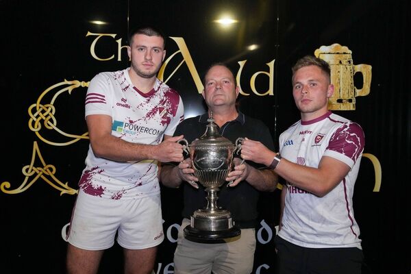 Dan Lynam (Caragh captain), Dan Curtis (Auld Shebeen, sponsor) and Jack Barrett (Leixlip captain) with the Hugh Campion trophy Photo: James Lawlor