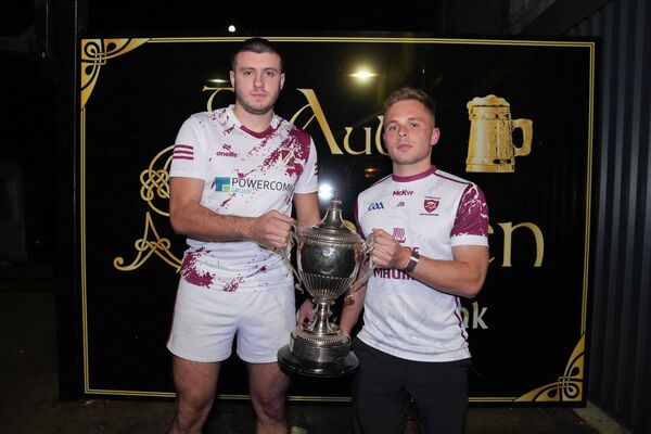 Dan Lynam (Caragh captain) and Jack Barrett (Leixlip captain) with the Hugh Campion trophy Photo: Sean Brilly