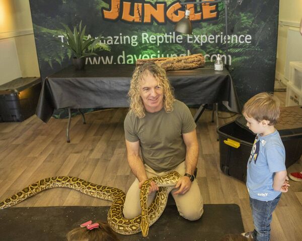 Dave from Dave's Jungle with Sean the python as Mikko watches on during Dad Fest in Athy Town Soccer Club Photos: Aisling Hyland