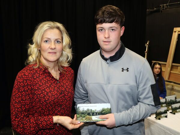 Jack Courtney accepting his Excellence in Sports award from KCA's Ilona Brede
