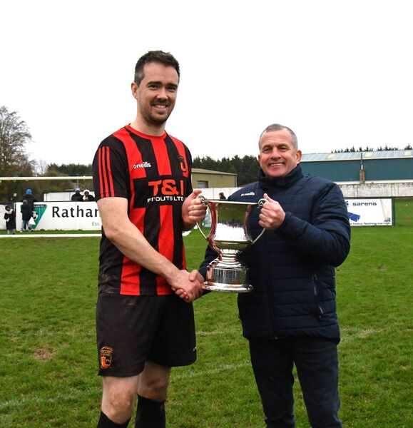Robbie Donnelly presents the Karina Donnelly Cup, a trophy named in honour of his late wife, to Clane Utd captain Jack Kelly Photo: Michael Anderson Robbie Donnelly presents the Karina Donnelly Cup, a trophy named in honour of his late wife, to Clane Utd captain Jack Kelly Photo: Michael Anderson