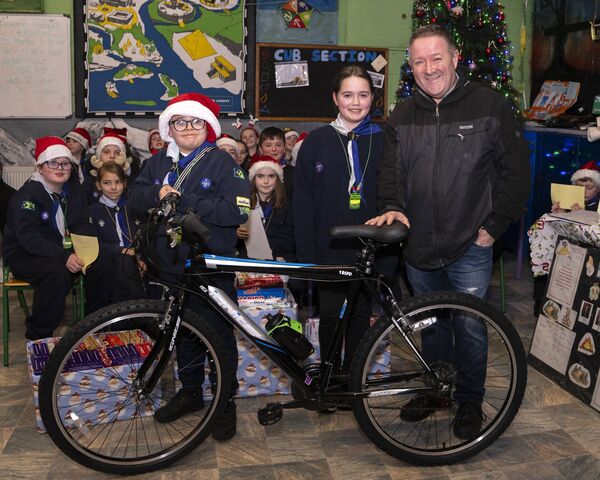 Chad Hutchinson, and Niamh Hurley of Athy Cubs with a bicycle donated to the club by Declan Byrne 