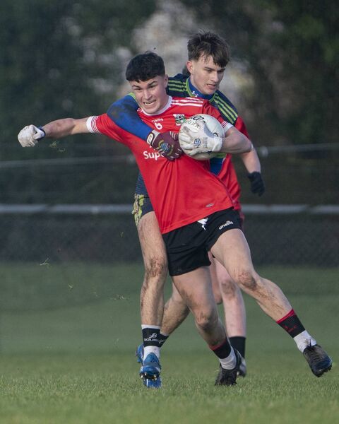 St Laurences man James Donnelly holds onto to the ball for Ardscoil Na Trionoide Photo: Aisling Hyland