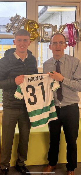 Michael Noonan presents Paul Murphy, principal of Ardscoil Rath Iomhgháin, with a Shamrock Rovers jersey