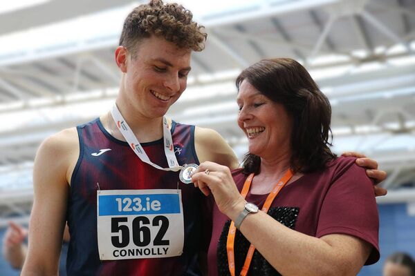 Ciaran Connolly (Le Cheile) with Coach Lisa Dixon admiring his gold medal at the All Ireland Indoors Photo: Perri Williams