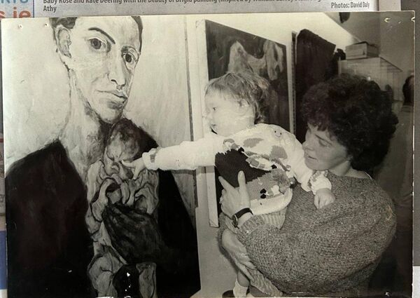 Ellen Dunne holding Kate Dunne at an art exhibition in 1992