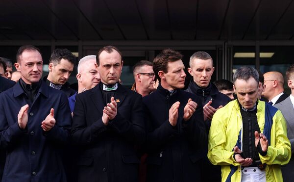  Jockeys applaud during a minute’s applause for Michael O’Sullivan prior to the start of the Cheltenham Festival Photo: ©INPHO/Tom Maher