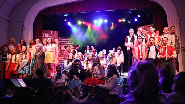 Some of the cast singing the opening number Some of the cast singing the opening number