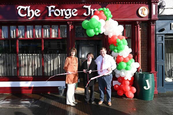 Gerry and Annette Roche cutting the Ribbon with Josie Kelly well known Lady from Naas 