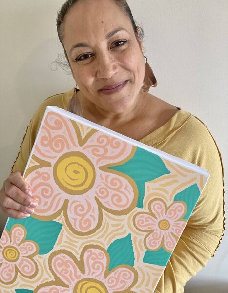 Artist Charlene Potts posing with one of her paintings