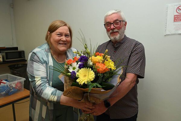 Imelda Carroll and Martin Hamill with a presentation of flowers to Imelda who is retiring later this year as adult literacy officer
