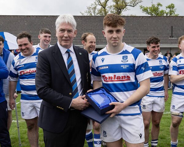 Declan Gardiner (Leinster President) presents the man of the match award to Athy's Aidan Henry
