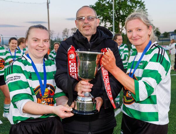 Brian O’Reilly (Hon Sec Carlow and District Football League) presents the Women’s Carlow Cup to Mill Celtic’s joint captain’s Deirbhle Byrne and Margaret Nolan Photo: michaelorourkephotography.ie