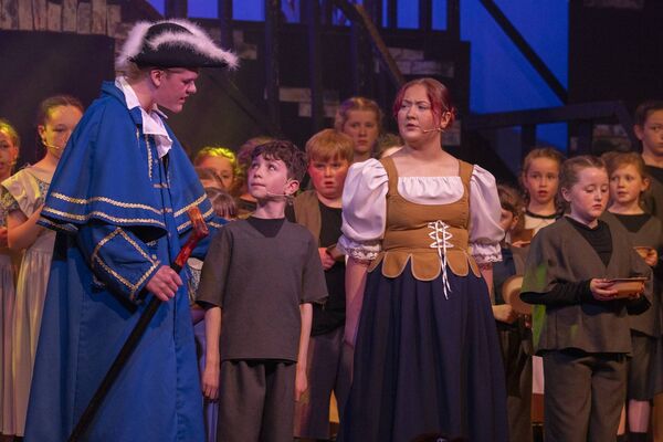 Mr Bumblle - Joe Moore, Oliver - John Scully and Widow Corney- Makayla Farrell on stage 