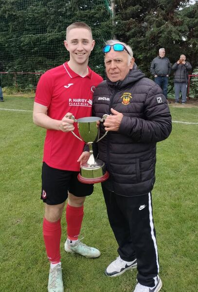Captain Cian Delaney is presented with the cup