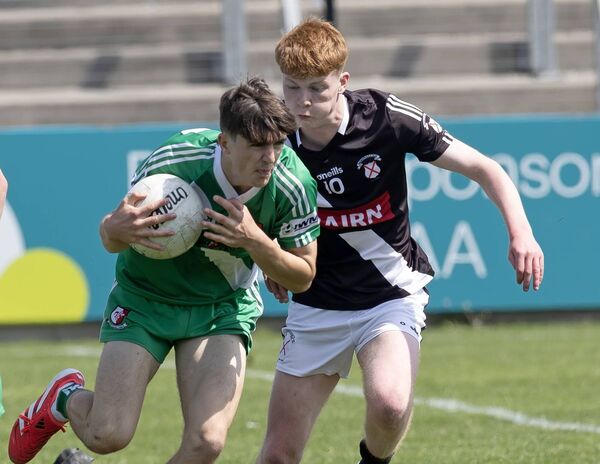 Sarsfields' Conor Lawless tries to free himself from the attentions of Maynooth' Cillian Price Photo: Sean Brilly