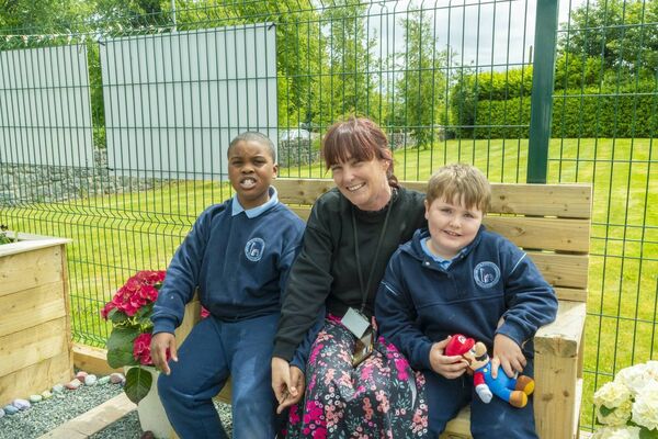 Joshua and Kayden enjoying the garden with Muinteoir Harris
