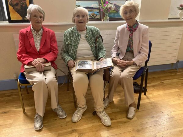 Mary Jo Fitzpatrick (centre) shows her photograph album on the guild's activities since 1965 to long-time Castledermot guild members Maureen O'Gorman and Rosaleen Murphy