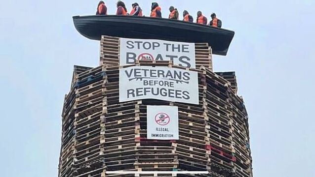 Calls for removal of migrant effigies in boat placed on loyalist bonfire in NI