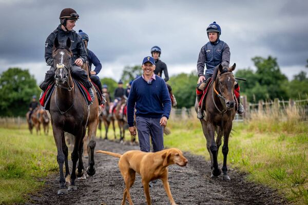Trainer Ross O’Sullivan walks alongside Donagh Meyler on Donnie Devito ahead of the Galway Races Photos: ©INPHO/Morgan Treacy