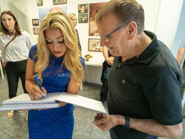 Antoinette signs a book for Dave Daly.