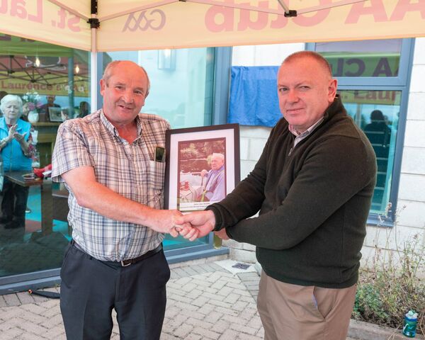 Bill Mackey from Larries on the Move maKeS a presentation to John Joe's son, John Walsh