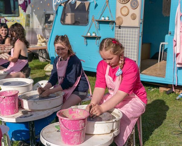 Aine Mulhall and Riley Higgins try out some Pottery at the Picnic