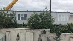School prefab is overlooking local homes