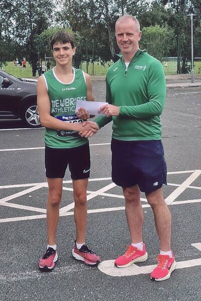 Paul Archbold presents Alex Guther with his first male Junior at the Newbridge 5km Photo: Newbridge AC