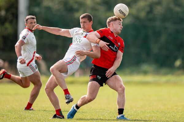 Rathangan's Muiris Curtin and Milltown's Liam Kelly, both team remain strongly in the running heading into the quarter-finals ©James Lawlor Photos