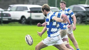 <p class="contextmenu internal_Caption">Captain Craig Miller kicks for Athy</p>