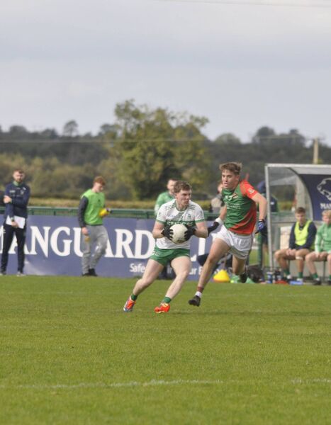 James Dalton of Sallins dances around Suncroft's Conor Martin. James Dalton of Sallins dances around Suncroft's Conor Martin.