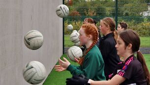 <p>Scoil Bhride NS footballers try out the new skills wall</p>