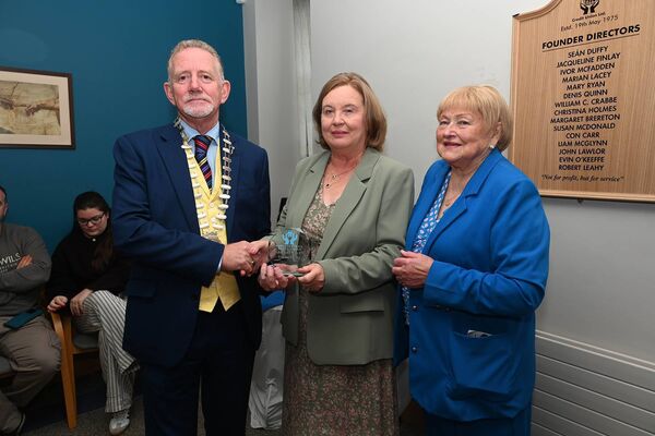 Mary Byrne receiving a plaque for her late father Liam McGlynn, a founding director, by Brendan Jenkins and Mary Ryan 