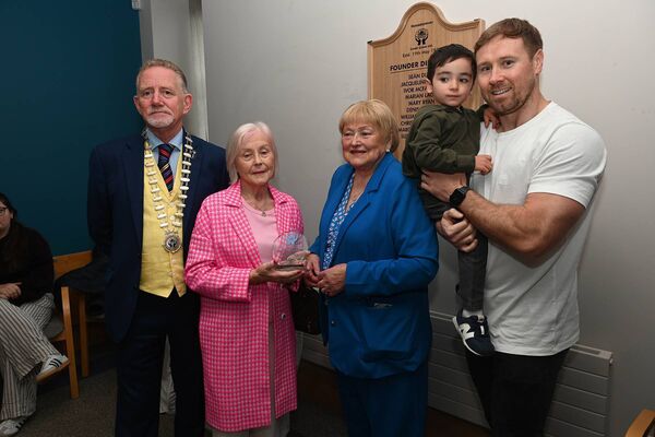  Carmel Timoney recieving a plaque for her dad the late Con Carr along with Fionn and Con Carr 
