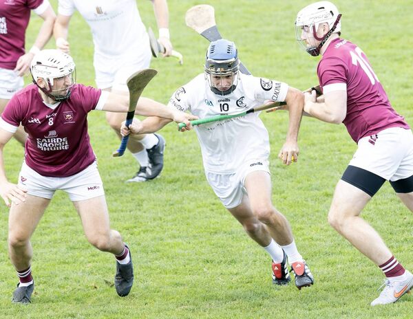 Clane's Sean Malone breaks through the tackles of Leixlip's Cathal Derivan and Ben Travers