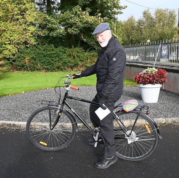 Fr John Fitzpatrick on his bike at his retirement 