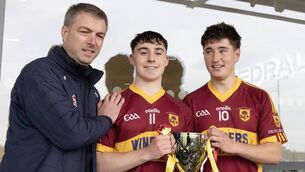 <p>Éire Óg Corra Choill joint captains Simon Connolly and Donnchadh Fitzpatrick receive the Minor B Hurling trophy from Kildare GAA treasurer Alan Dunney Photo: Sean Brilly</p>