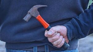 Two men threaten woman with hammers Two men threaten woman with hammers
