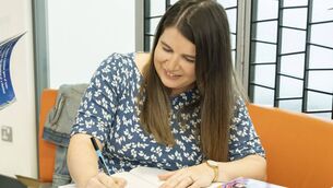<p>Author Steffi Fennelly signing a copy of her book <span class="contextmenu quote">The World is in our Hands</span>in Athy Library Photos: Aisling Hyland</p>