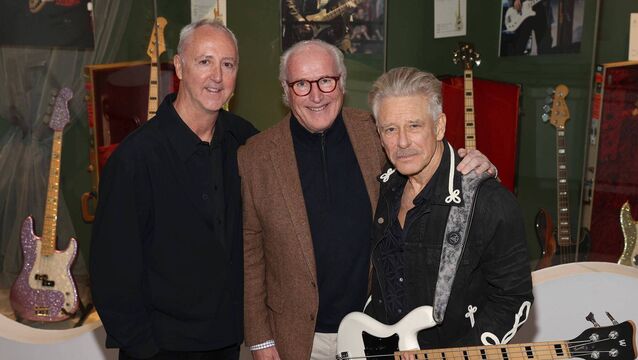 <p>Adam Clayton photographed with William Doyle, CEO of Newbridge Silverware and Museum of Style Icons, and Martin Nolan of Julien's Auctions</p>
